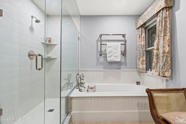 a bathroom with a bathtub and a shower