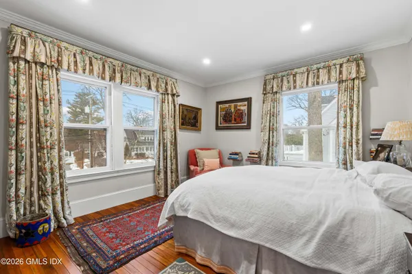 a bed sitting in a bedroom next to a window
