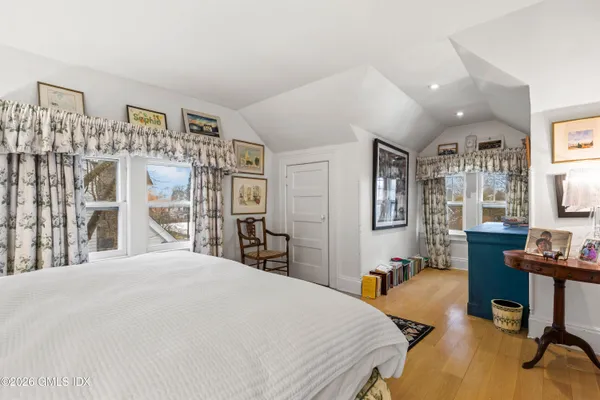 a bedroom with a large bed and a desk