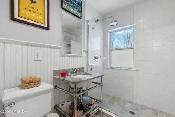 a bathroom with a sink toilet and shower