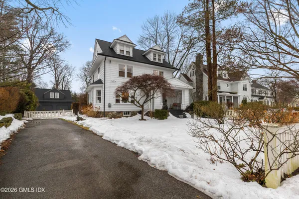 a view of a house with snow on the road