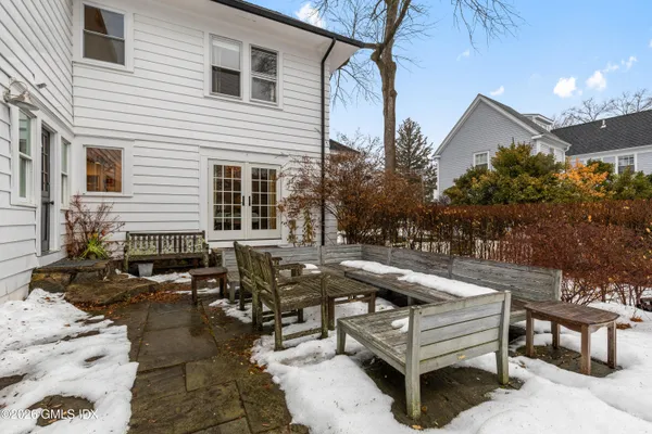 a view of a patio with couches table and chairs and potted plants