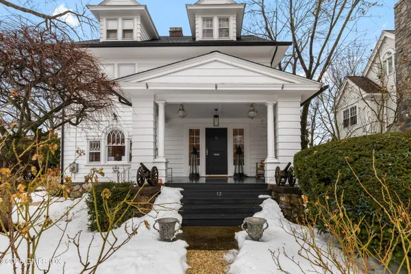 a view of a house with a chairs and table in a patio
