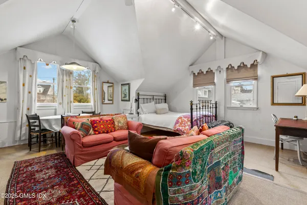 a living room with furniture a rug and a chandelier