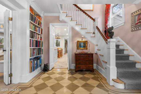 a view of entryway and hall with wooden floor
