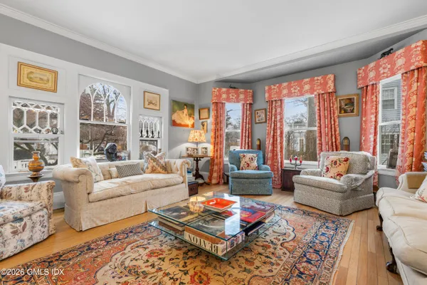 a living room with furniture couches and a large window