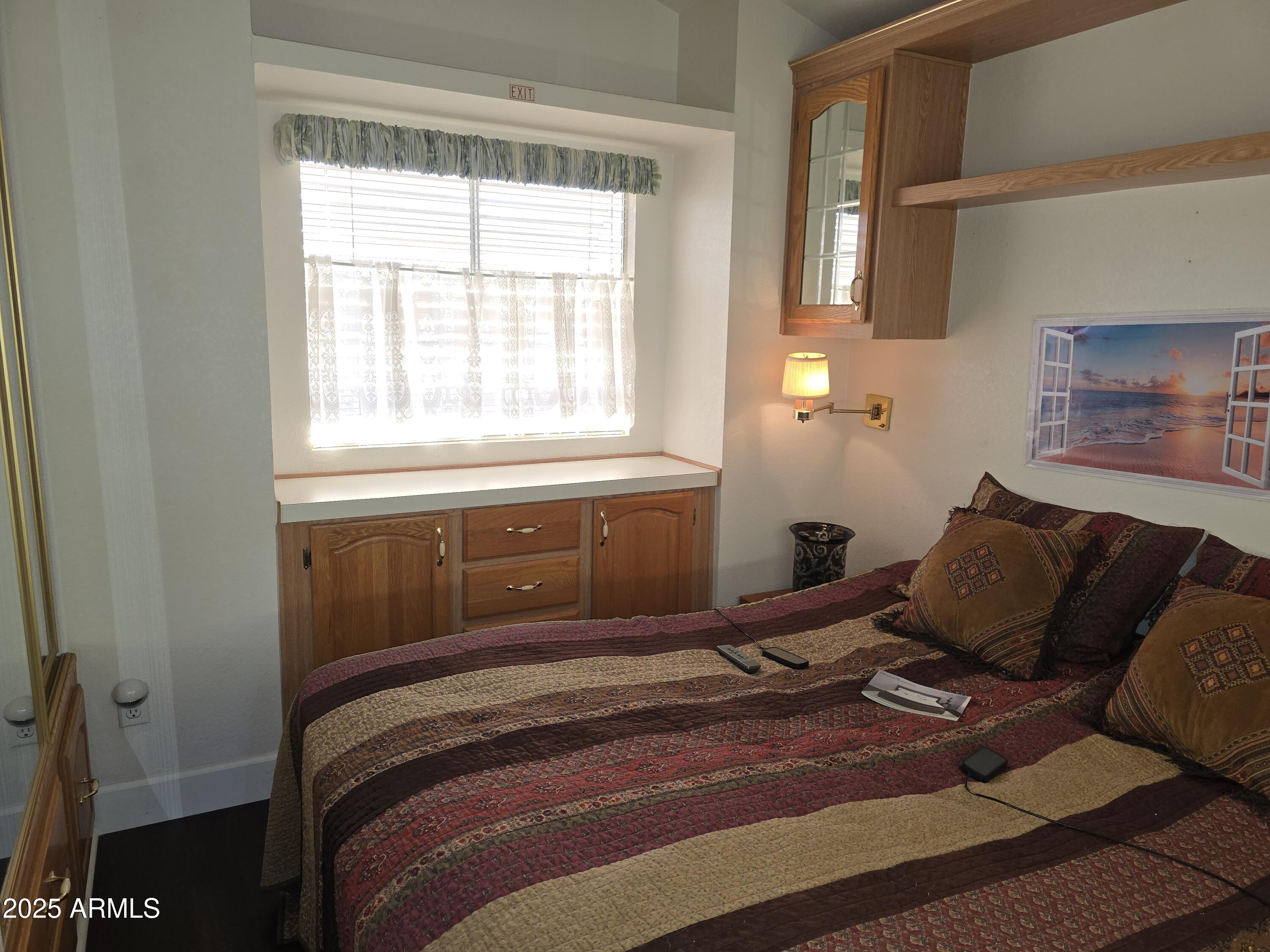 2090 South Cherokee Drive Apache Junction, AZ 85119 - Photo 11 of 11 a bedroom with a bed and window