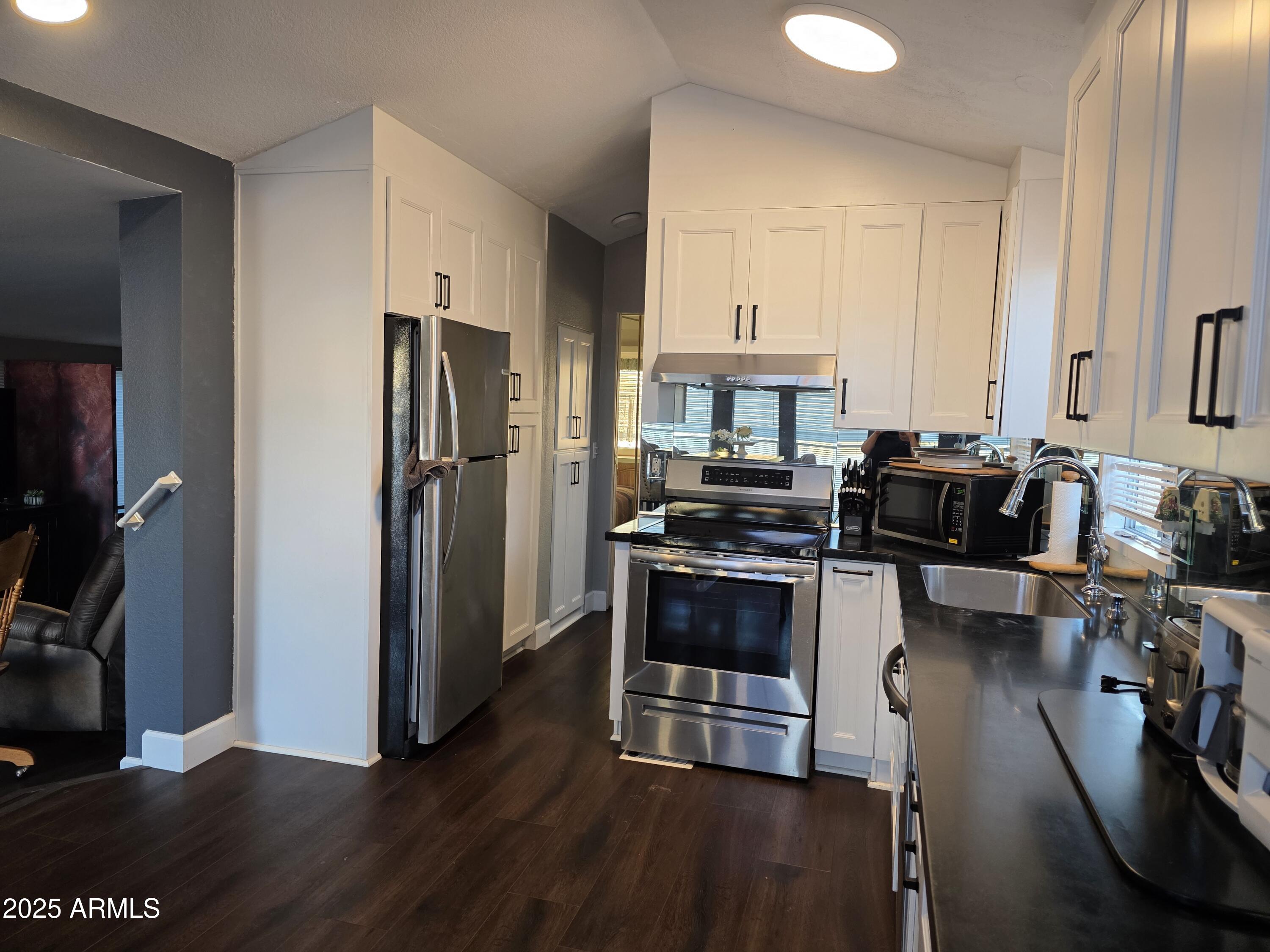 2090 South Cherokee Drive Apache Junction, AZ 85119 - Photo 5 of 11 a kitchen with stainless steel appliances a refrigerator a stove a sink and a stove