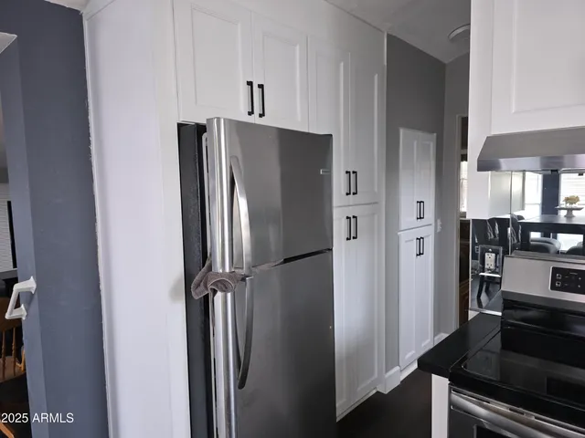 a kitchen with stainless steel appliances a refrigerator and cabinets