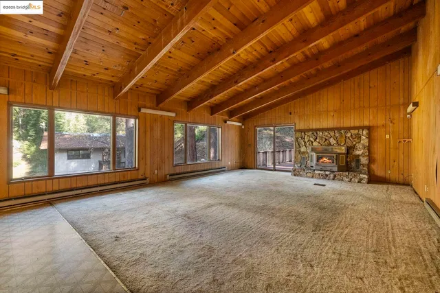 a view of a livingroom with wooden floor and a window