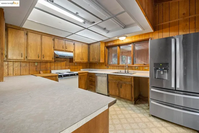 a kitchen with a sink appliances and cabinets