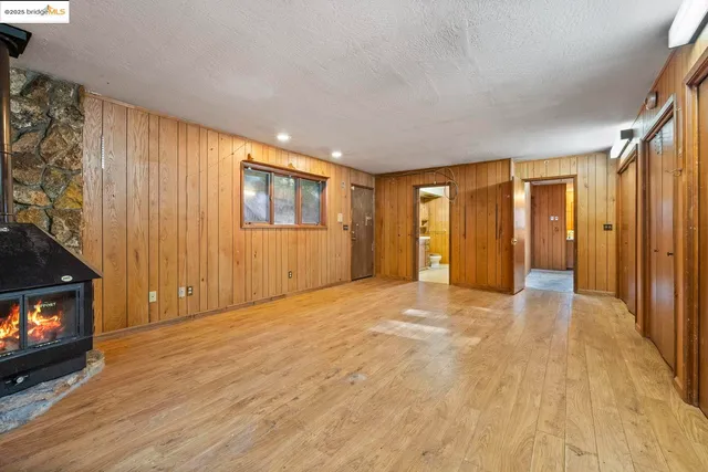 a view of an empty room with a fireplace