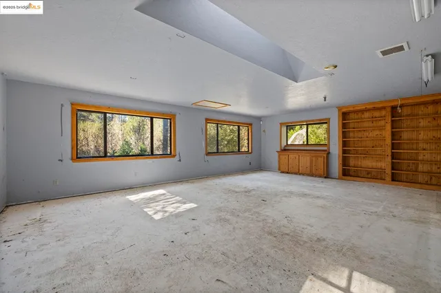 a view of empty room with windows