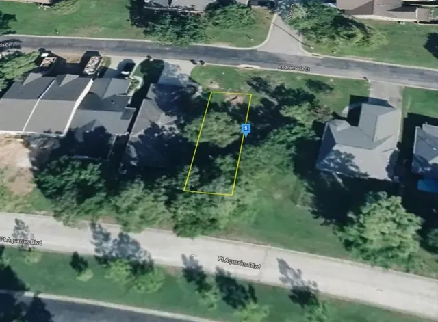 an aerial view of a house with a yard and potted plants