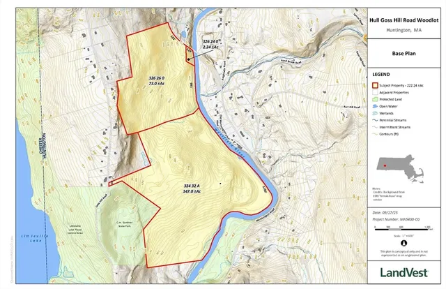 a view of a field with mountains in the background