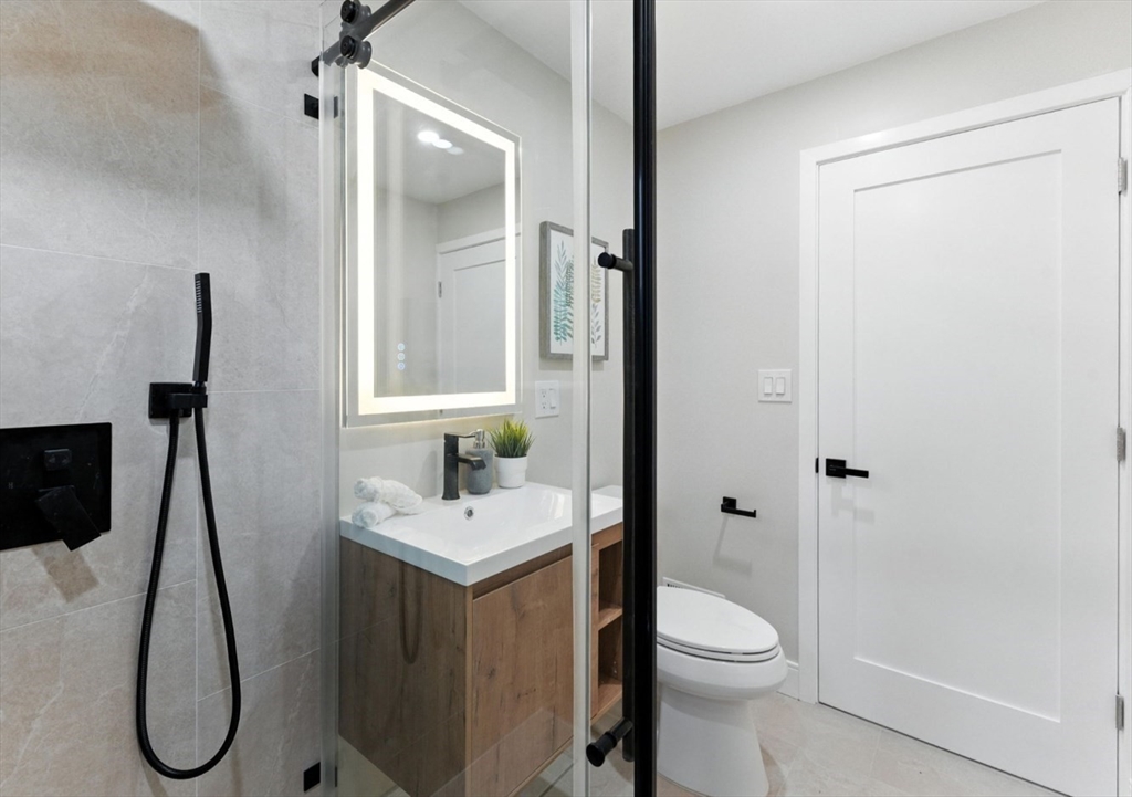 76 Orchard Street, Unit 76 Medford, MA 02155 - Photo 11 of 21 a bathroom with a sink toilet and shower