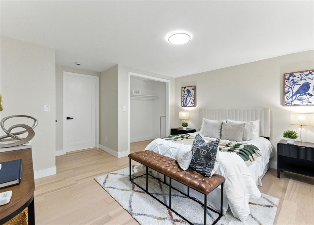 76 Orchard Street, Unit 76 Medford, MA 02155 - Photo 14 of 21 a bedroom with bed a couch and a stove top oven