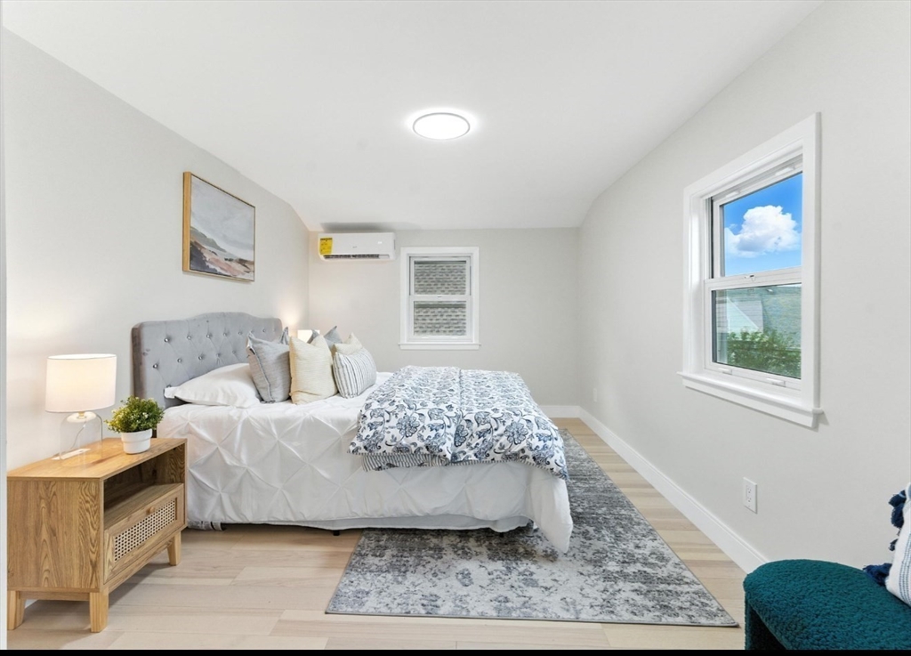 76 Orchard Street, Unit 76 Medford, MA 02155 - Photo 17 of 21 a living room with a bed and a couch