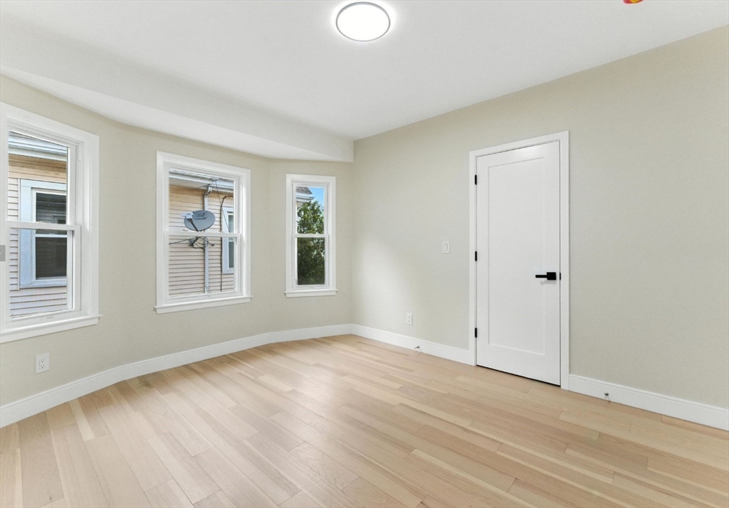 76 Orchard Street, Unit 76 Medford, MA 02155 - Photo 8 of 21 a view of empty room with wooden floor and fan