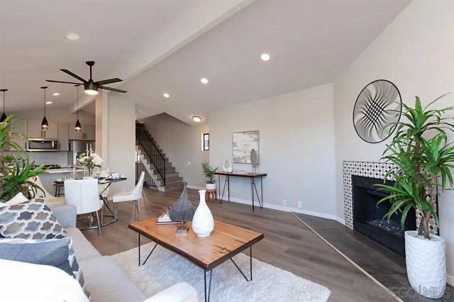 a living room with furniture a fireplace and a potted plant