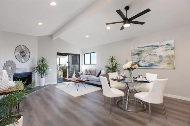 a living room with furniture a fireplace and a potted plant