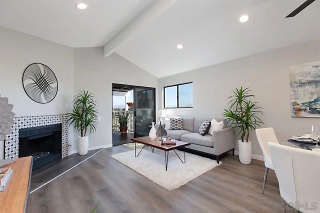 a view of a dining room with furniture and a potted plant