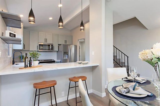 a kitchen with stainless steel appliances a sink a stove cabinets and a counter top space