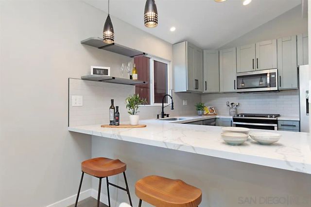 a kitchen with cabinets and stainless steel appliances