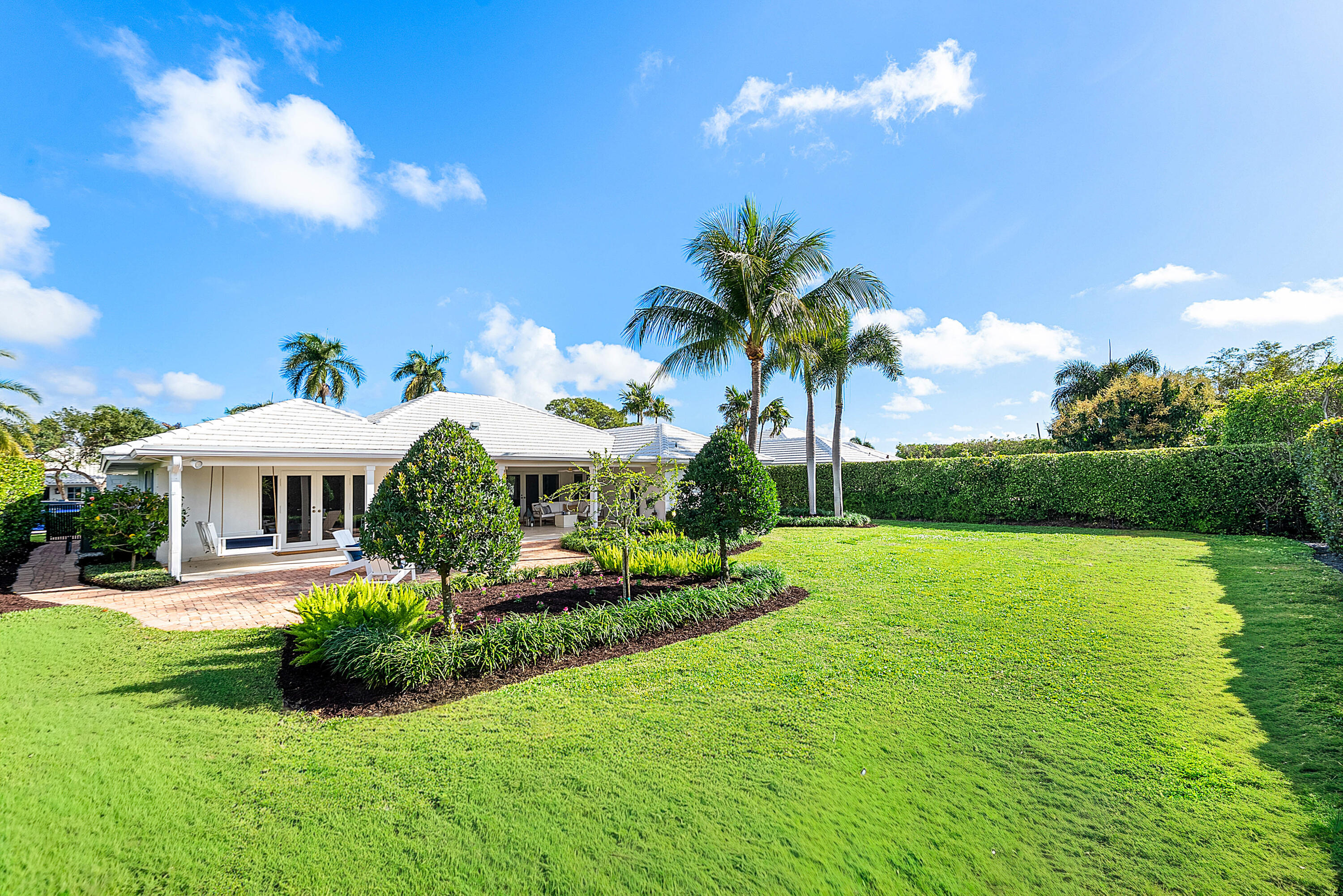 670 Elm Tree Lane Boca Raton, FL 33486 - Photo 14 of 44 a front view of a house with garden