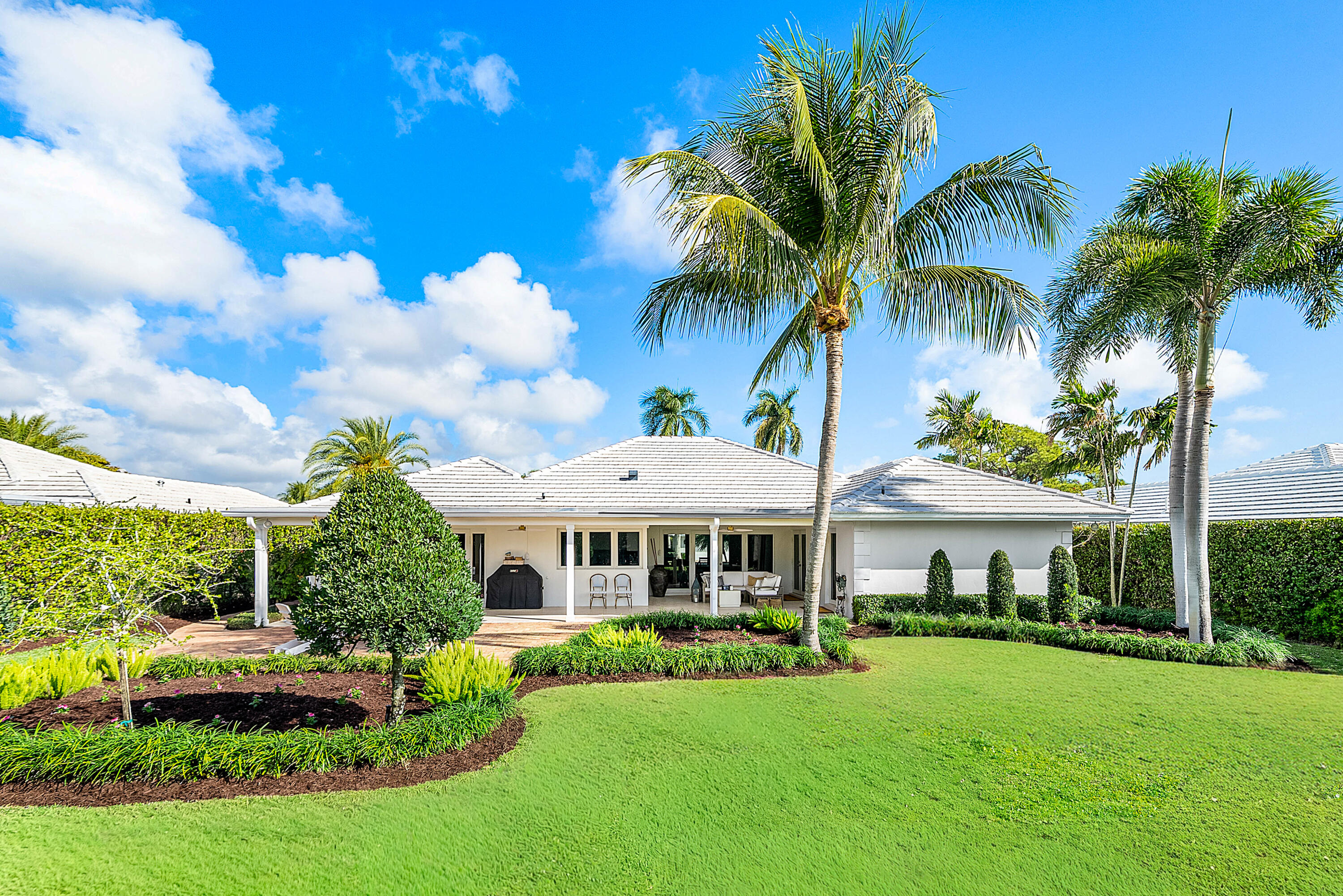670 Elm Tree Lane Boca Raton, FL 33486 - Photo 15 of 44 a front view of a house with a yard