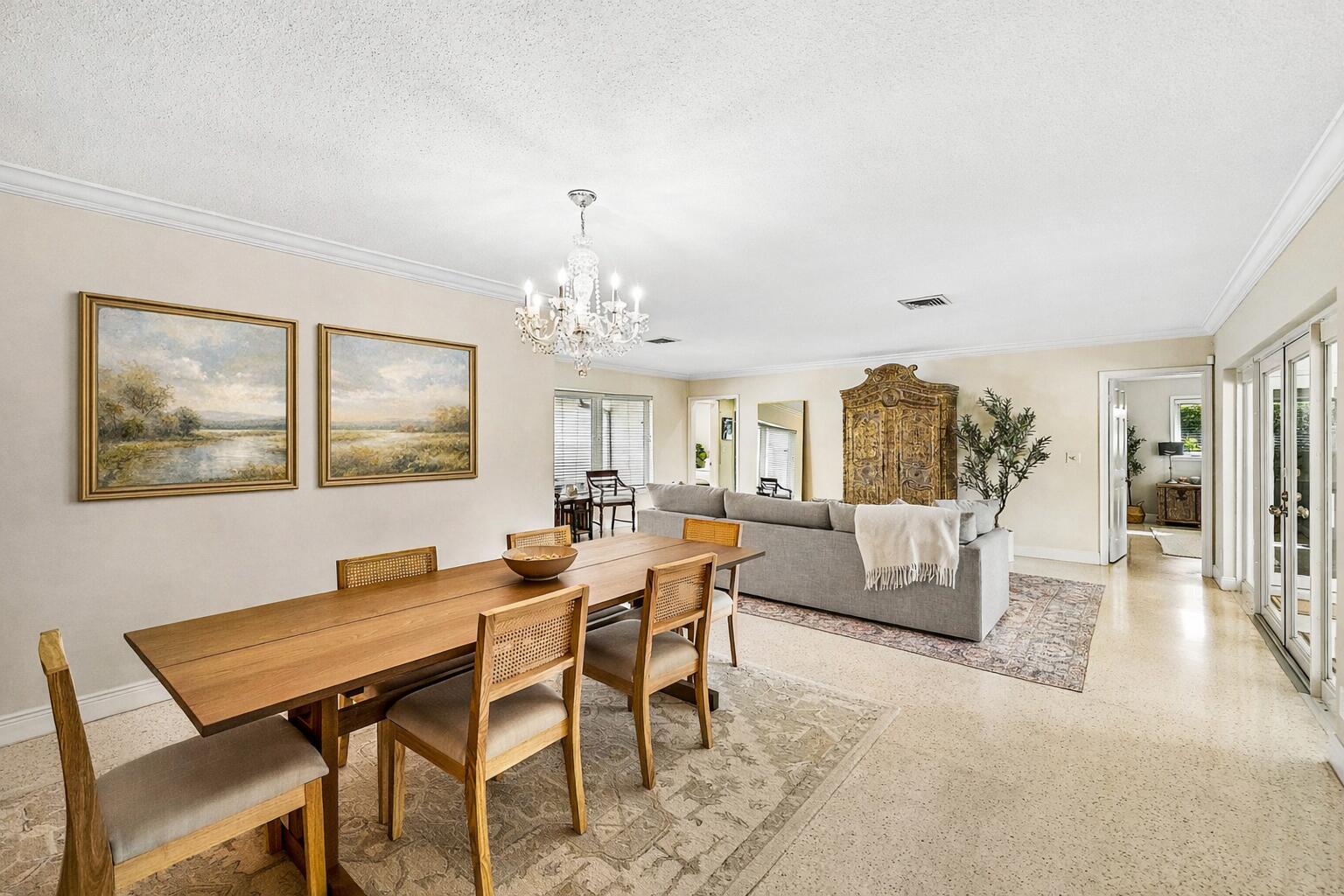 670 Elm Tree Lane Boca Raton, FL 33486 - Photo 17 of 44 a view of a dining room with furniture a chandelier and wooden floor