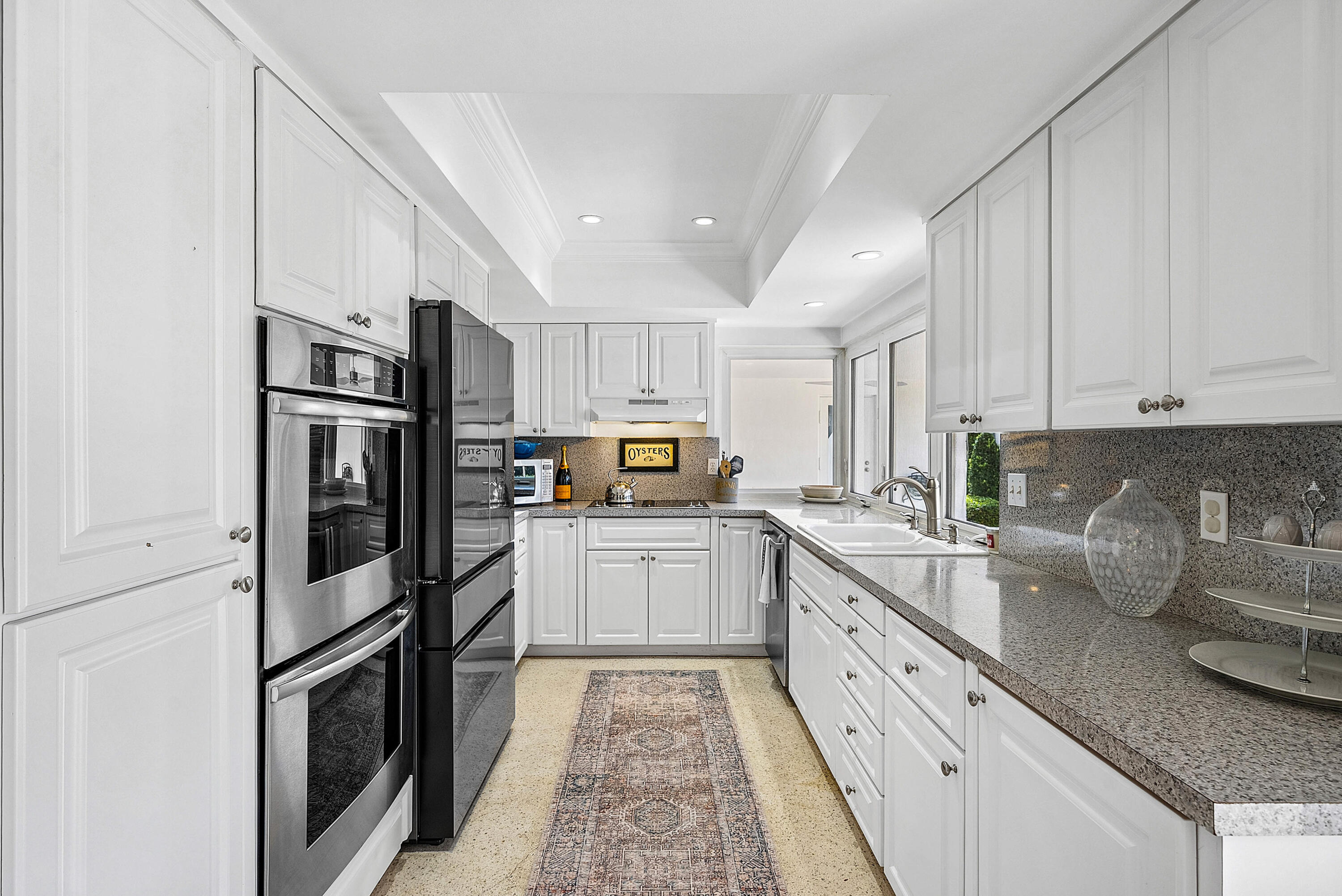 670 Elm Tree Lane Boca Raton, FL 33486 - Photo 23 of 44 a kitchen with granite countertop stainless steel appliances and counter space
