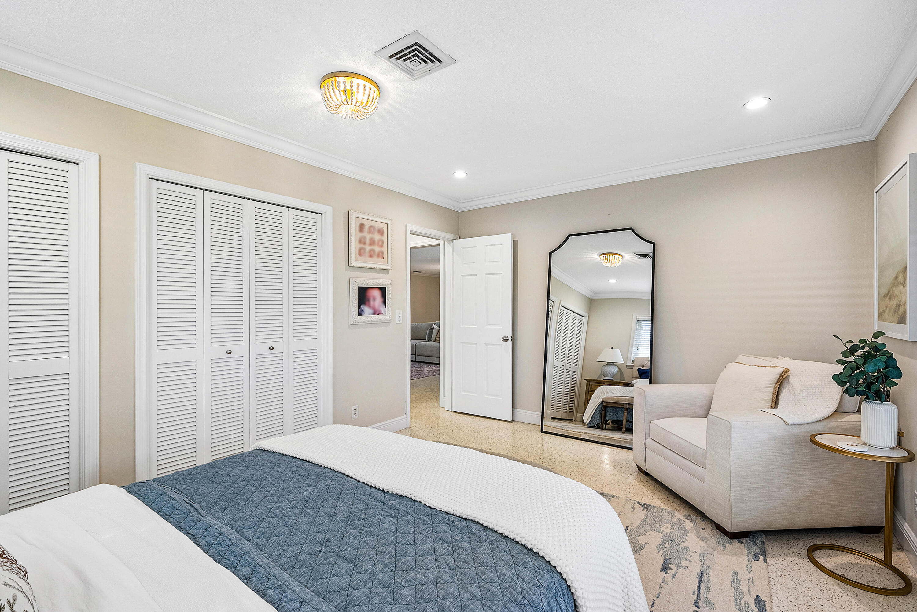 670 Elm Tree Lane Boca Raton, FL 33486 - Photo 26 of 44 a spacious bedroom with a bed and a chandelier
