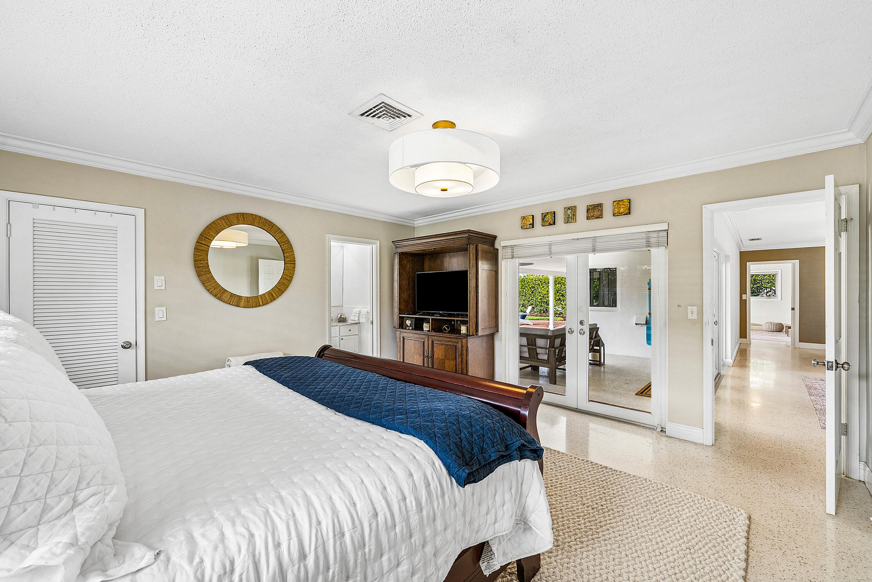 670 Elm Tree Lane Boca Raton, FL 33486 - Photo 28 of 44 a bedroom with a large bed and a chandelier