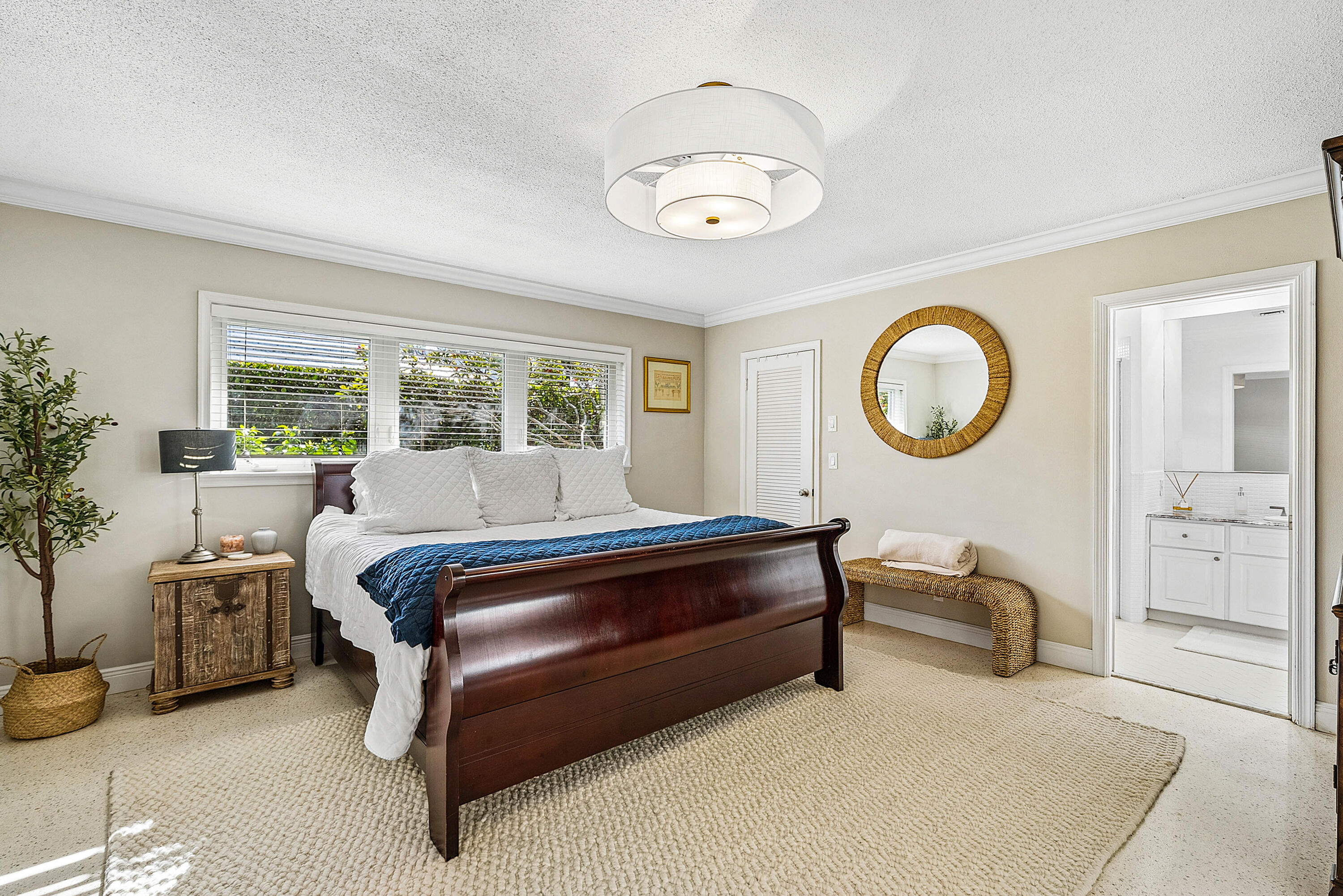 670 Elm Tree Lane Boca Raton, FL 33486 - Photo 29 of 44 a bedroom with a bed and a chandelier