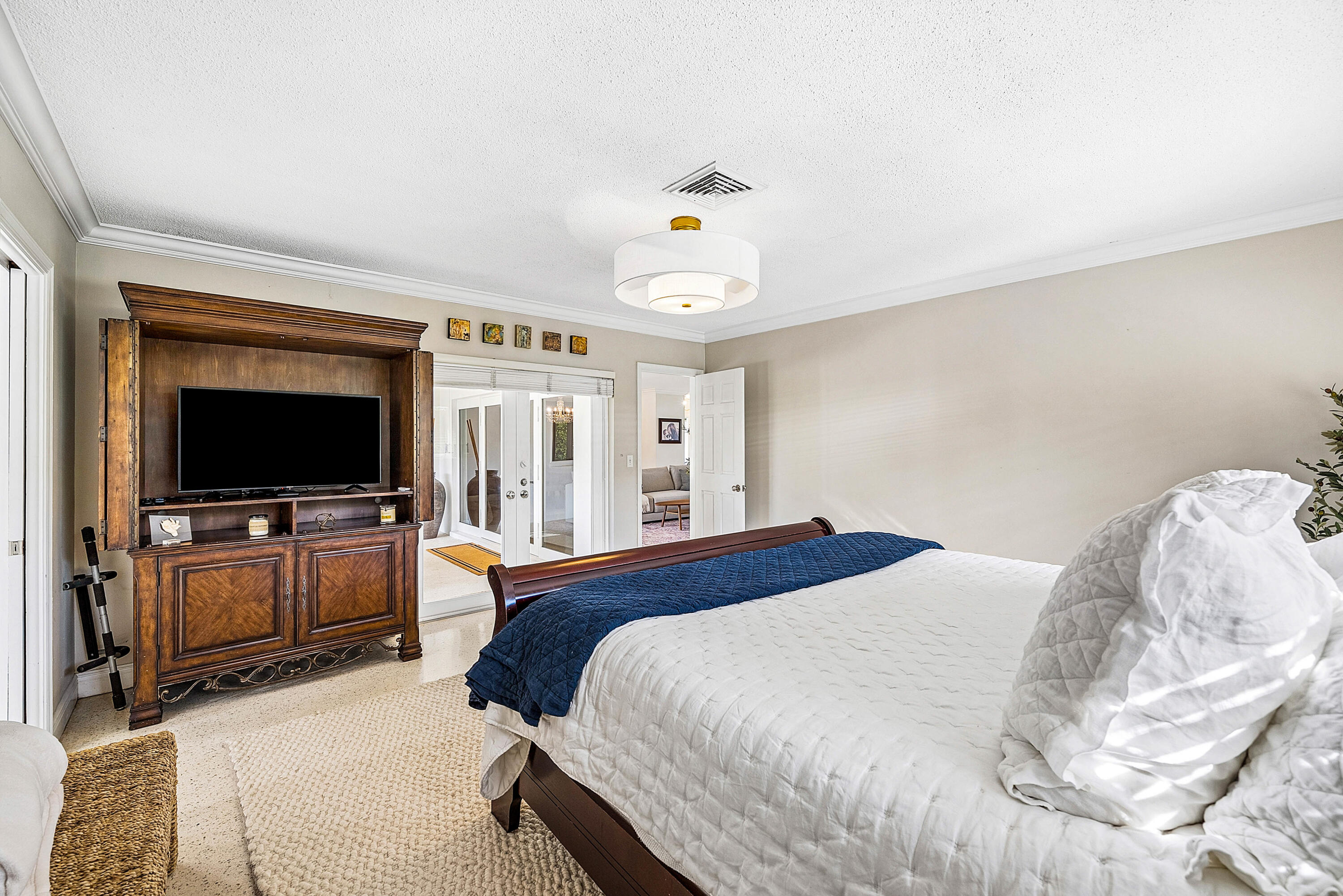 670 Elm Tree Lane Boca Raton, FL 33486 - Photo 30 of 44 a bedroom with a bed and a flat screen tv