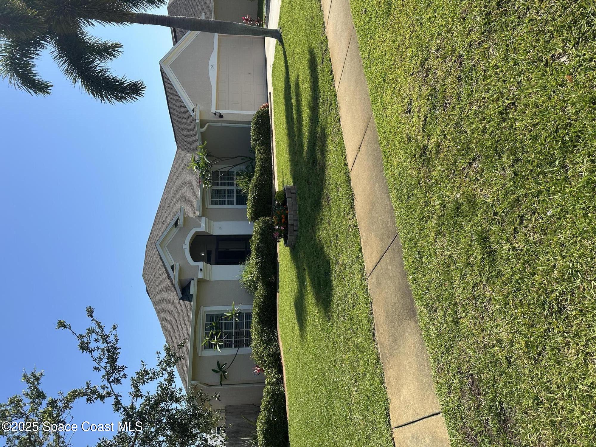 1354 Enclave Drive Rockledge, FL 32955 - Photo 1 of 27 a front view of a house with a yard