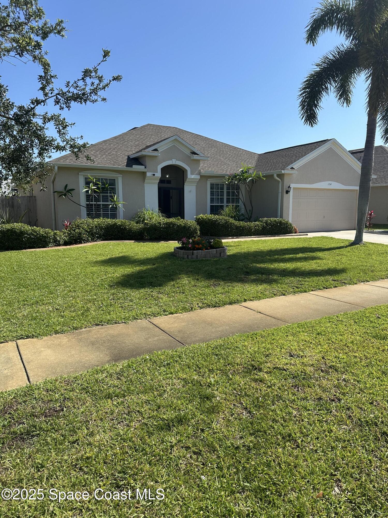 1354 Enclave Drive Rockledge, FL 32955 - Photo 26 of 27 a front view of a house with a yard