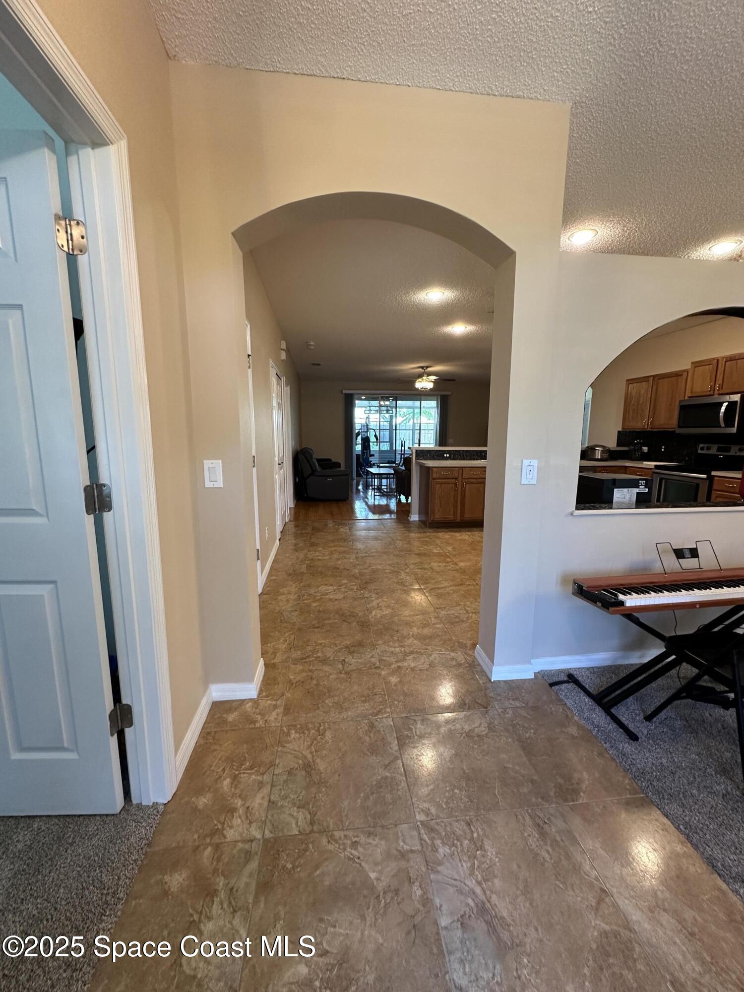 1354 Enclave Drive Rockledge, FL 32955 - Photo 8 of 27 a view of a hallway with a car garage