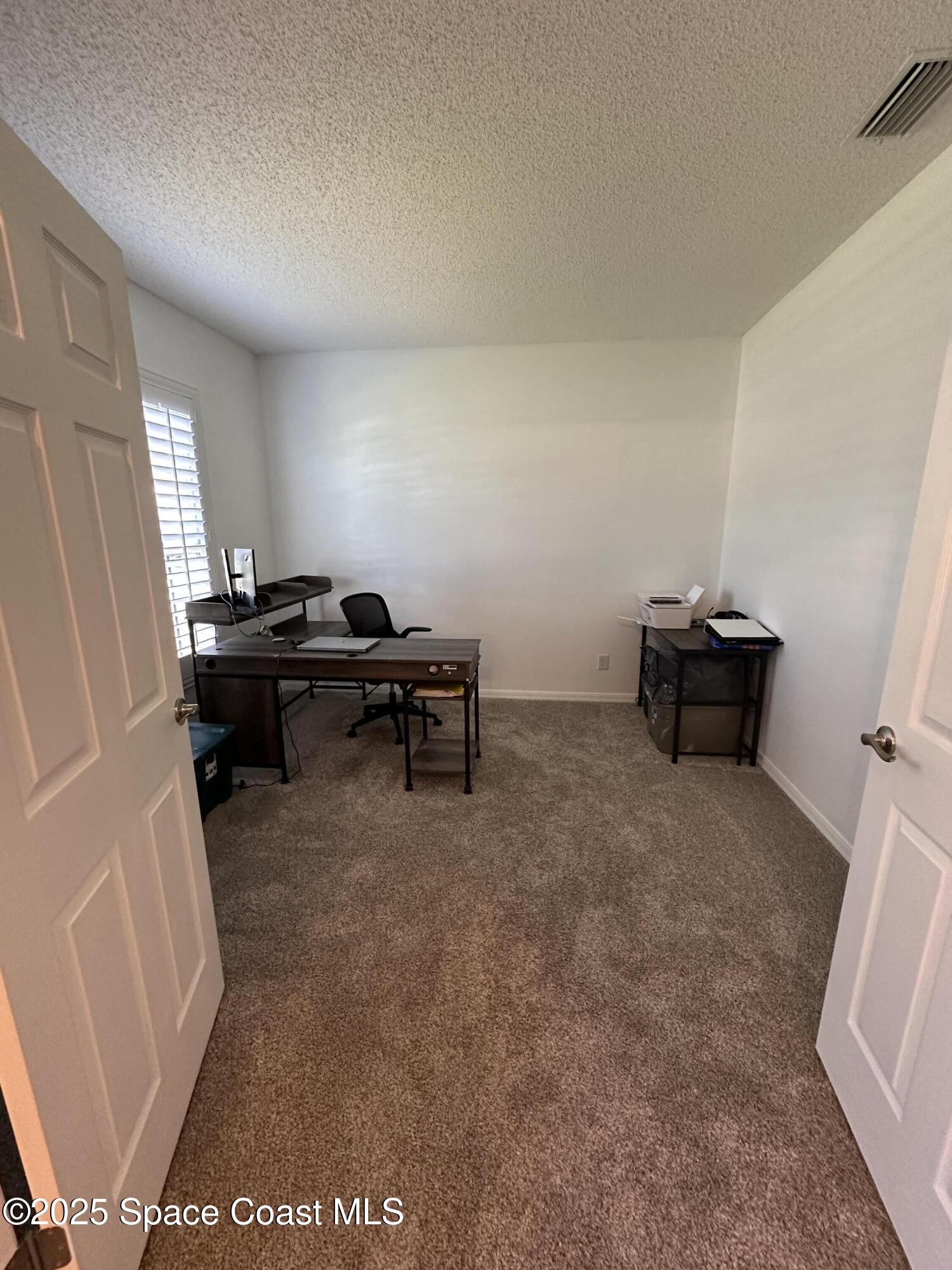 1354 Enclave Drive Rockledge, FL 32955 - Photo 10 of 27 a livingroom with workspace and a window