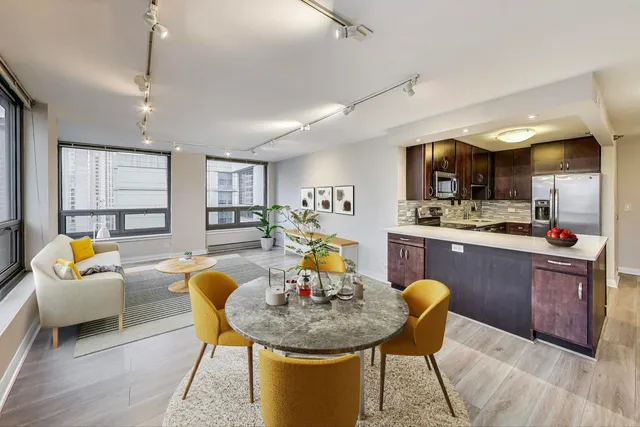 a living room with furniture and kitchen view
