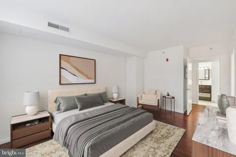 a bedroom with a bed and wooden floor