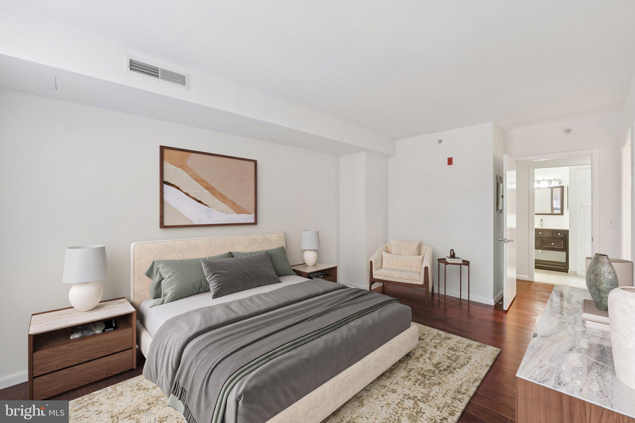 355 I Street Southwest, Unit 410 Washington, DC 20024 - Photo 16 of 31 a bedroom with a bed and wooden floor