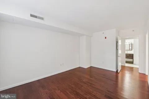 a view of a room with wooden floor