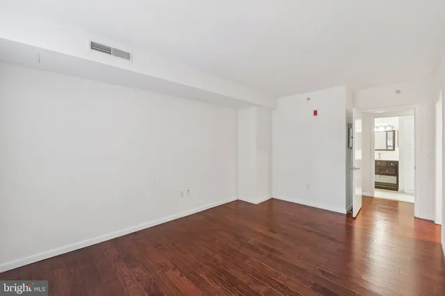 a view of a room with wooden floor