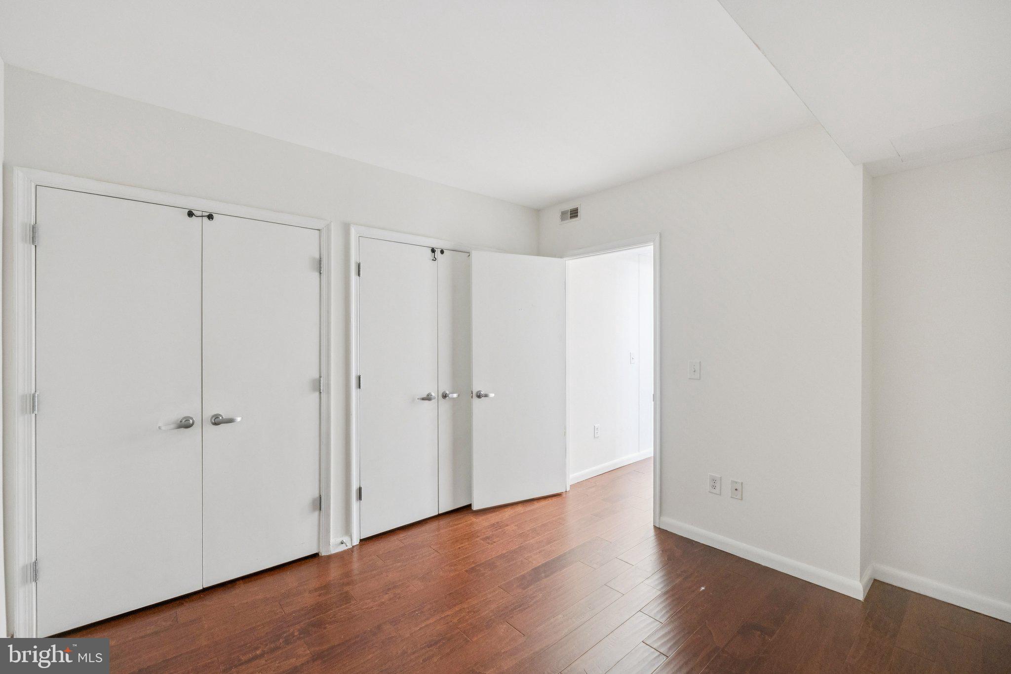 355 I Street Southwest, Unit 410 Washington, DC 20024 - Photo 23 of 31 a view of an empty room with wooden floor
