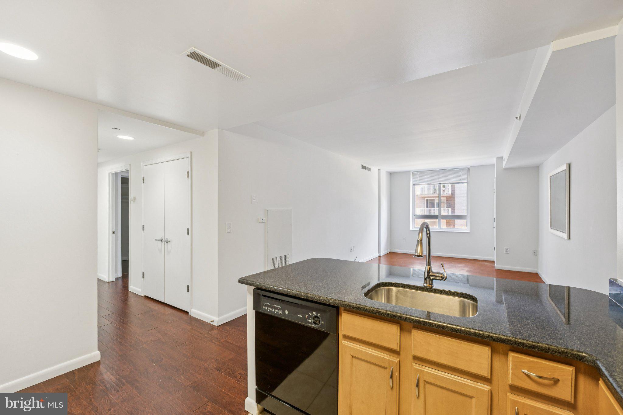 355 I Street Southwest, Unit 410 Washington, DC 20024 - Photo 29 of 31 a kitchen with kitchen island a sink and wooden floor