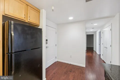a view of a refrigerator in kitchen and wooden floor