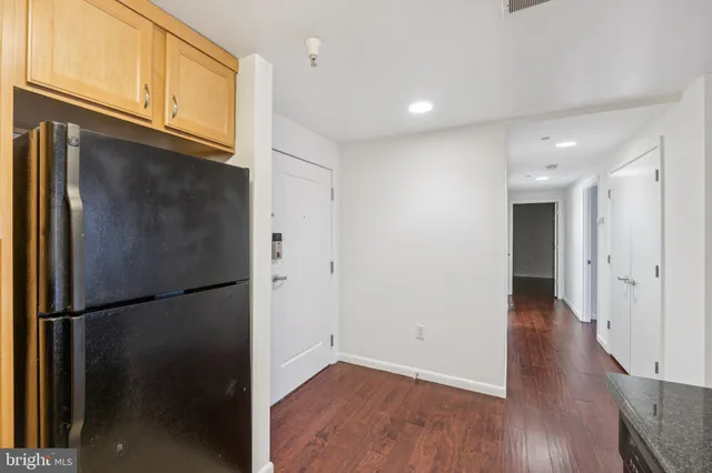 a view of a refrigerator in kitchen and wooden floor