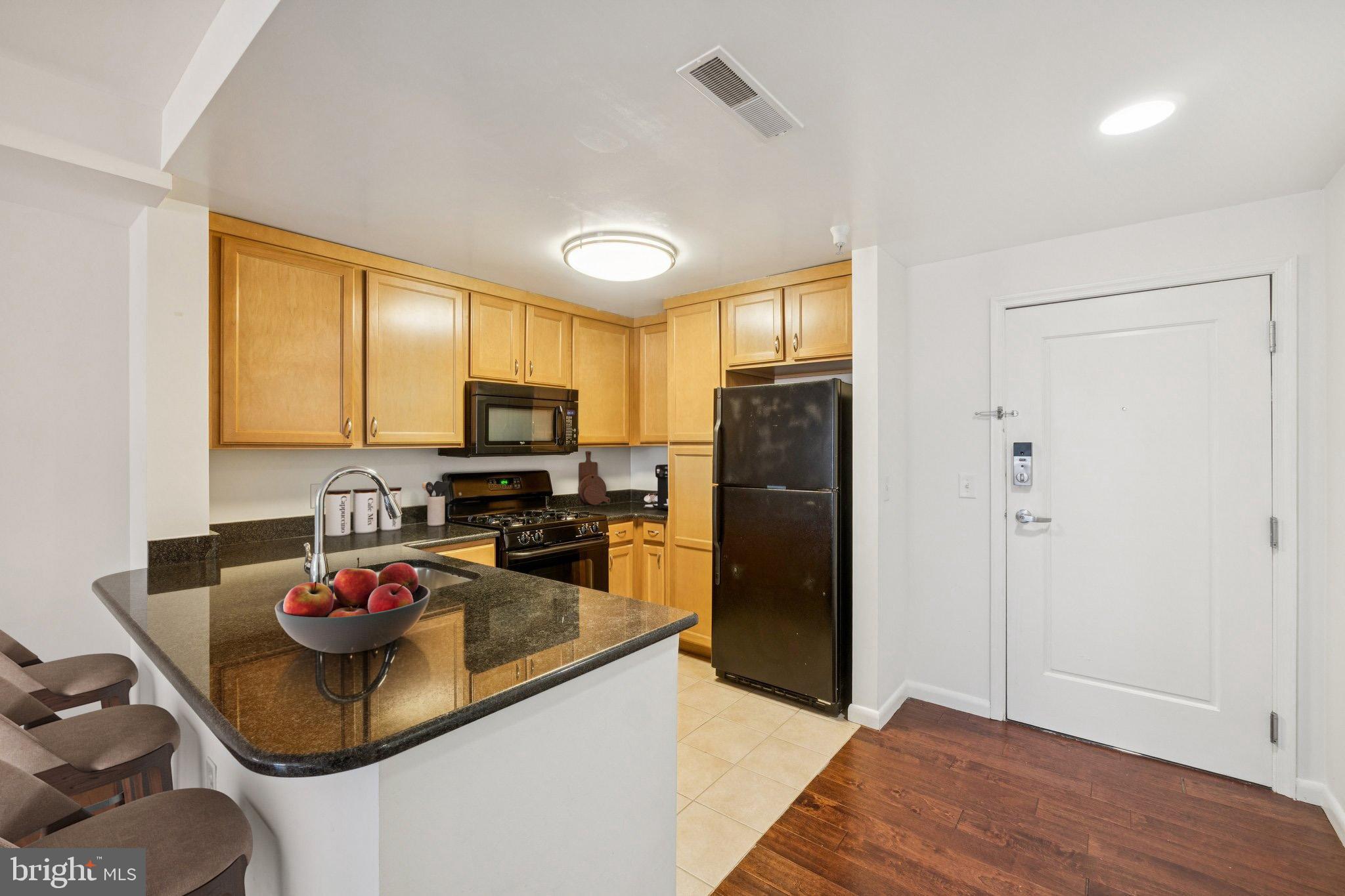 355 I Street Southwest, Unit 410 Washington, DC 20024 - Photo 5 of 31 a kitchen with a refrigerator and a stove top oven